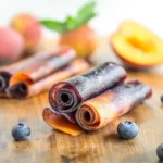 Homemade Blueberry Peach Fruit Roll-Ups made with fresh peaches and blueberries, rolled and ready to serve