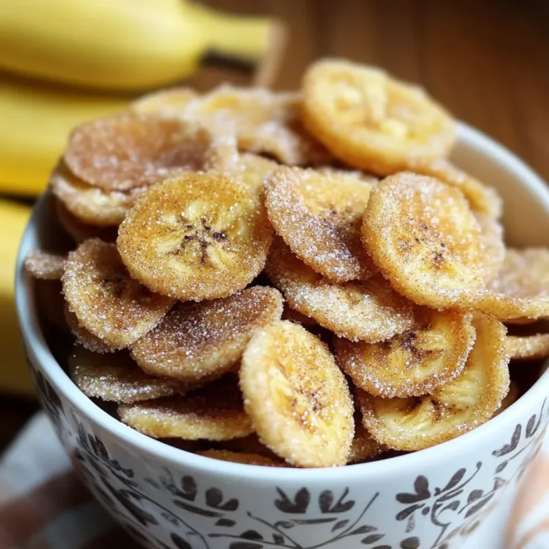 Homemade crispy cinnamon sugar banana chips in a floral bowl