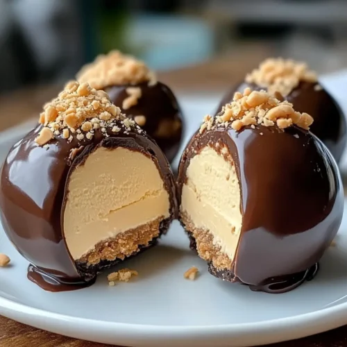 No-Bake Peanut Butter Cheesecake Balls coated in chocolate and topped with crushed peanuts