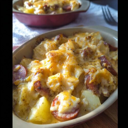 Close-up of a Cheesy Ranch Potato & Sausage Casserole, showing melted cheese, potatoes, and sausage slices.