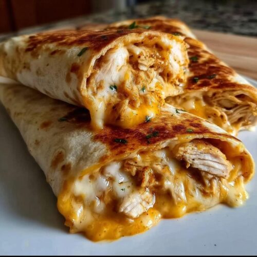 Close-up of Ooey Gooey BBQ Chicken & Cheese Wraps with melted cheese oozing out.