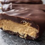 Close-up of a Chocolate Peanut Butter Freezer Bars showing the thick, creamy peanut butter center coated in rich chocolate.