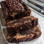 Close-up of sliced Healthy Chocolate Banana Bread topped with melted chocolate chips.