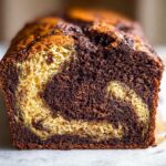 Close-up of a freshly baked Marbled Chocolate Banana Bread loaf showing the swirl pattern of light and dark chocolate batter.