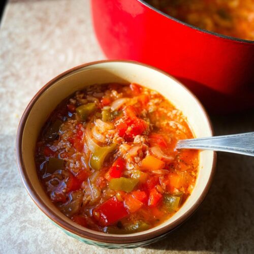 A close-up bowl of hearty 30-Minute Pepper Soup filled with colorful peppers, onions, and ground meat.