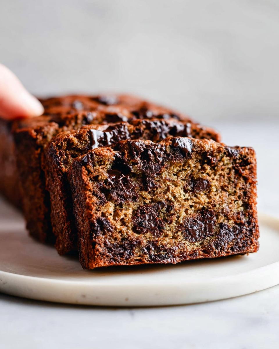 Close-up of thick slices of moist Bakery-Style Chocolate Chip Banana Bread loaded with melted chocolate chunks.