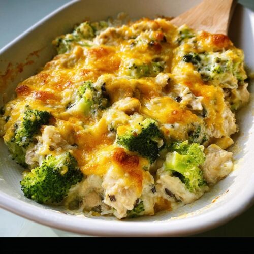 Close-up of a creamy Chicken Broccoli Low Carb Bake topped with melted, golden brown cheddar cheese.