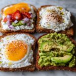Four different slices of Simple Savory Breakfast Toast featuring eggs, avocado, and fruit toppings.