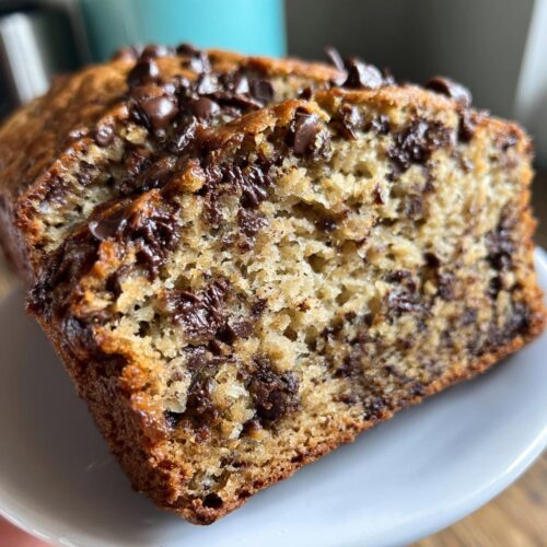 Close-up of moist slices of One-Bowl Chocolate Chip Banana Bread loaded with melted chocolate chips.