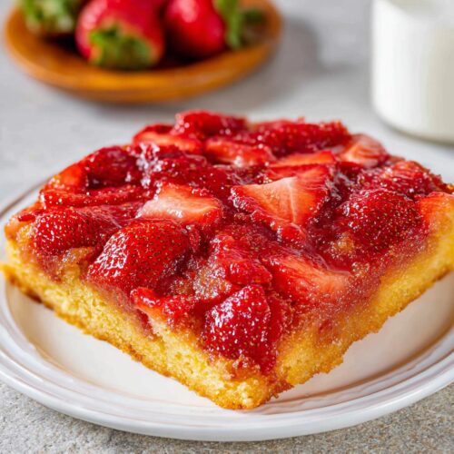 A square slice of Simple Strawberry Upside Down Dessert with caramelized strawberries on top.