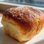 Close-up of a freshly baked, golden brown Sweet Breakfast Dough Made at Home, sprinkled with coarse sugar.