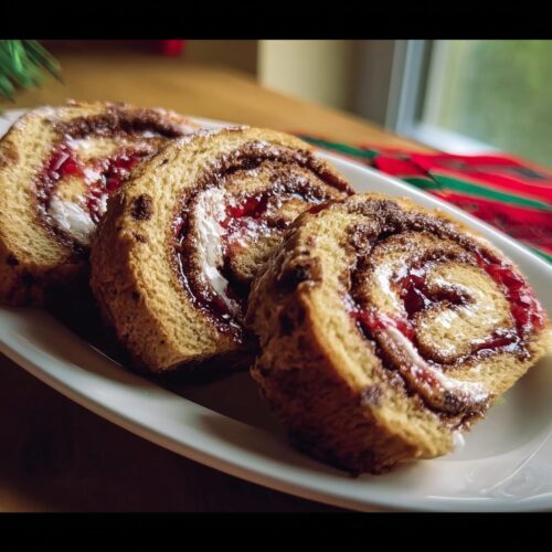 Three slices of Cherry Chocolate Swirl Rolls showing the rich cherry filling and chocolate swirl pattern.