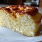 Close-up of a thick, fluffy slice from a Family-Style Baked Pancake Breakfast with a golden-brown top.