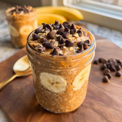 Close-up of Peanut Butter Banana Chocolate Chip Overnight Oats topped with chocolate chips in a mason jar.
