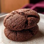 Close-up of two stacked Soft Chocolate Sugar Cookies, crinkled on top and coated generously with sparkling sugar.