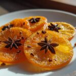 Close-up of glistening Spiced Candied Orange Slices garnished with whole star anise and cloves.