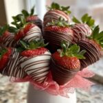 A beautiful bouquet of fresh strawberries dipped in dark and white chocolate, featuring a dark chocolate drizzle.