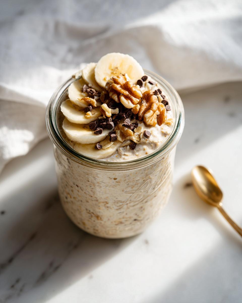 Close-up of Blended Banana Bread Overnight Oats topped with banana slices, walnuts, and chocolate chips.