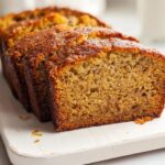 Close-up of thick slices of moist Bakery Style Banana Bread showing a rich, golden-brown crust.
