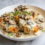 Golden seared chicken breasts smothered in a rich, creamy mushroom sauce, ready for the Creamy Summer Chicken Skillet.