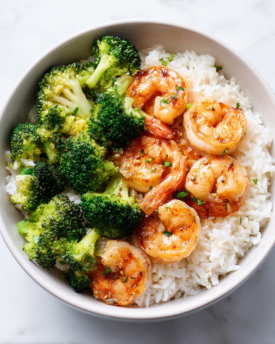 Close-up of a High Protein Summer Shrimp Bowl featuring glazed shrimp, steamed broccoli, and white rice in a light bowl.