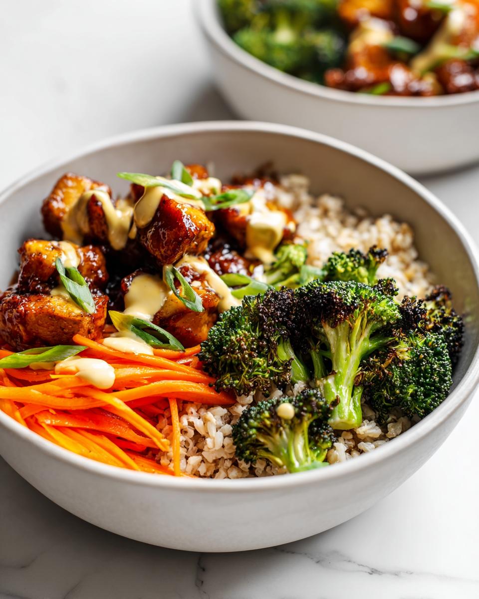 Close-up of a Summer Meal Prep Bowl featuring glazed tofu, roasted broccoli, shredded carrots, and brown rice.